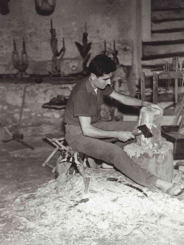 Pierre Dubosq sculptant du bois d'olivier en 1958